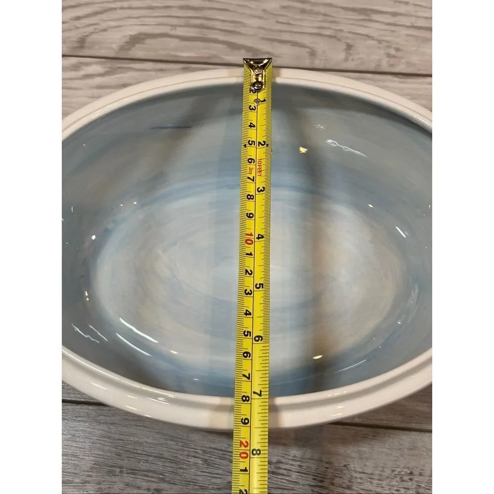 Temp-tations Ovenware by Tara Blue oval covered casserole dish with a metal stan